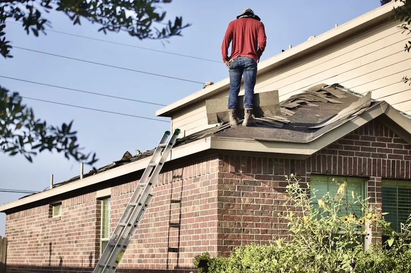 Professional roofer working on a residential roof in Haverford Village